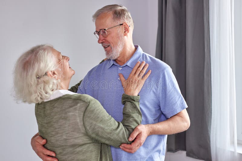 happy senior couple have fun dancing at home stock images