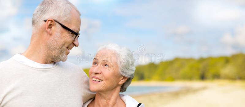 Happy senior couple hugging over beach background royalty free stock photo Happy senior couple hugging over beach background royalty free stock photo