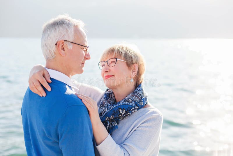 Happy senior couple at sea beach outdoor. Concept of wellbeing, happiness, male and female health, lifestyle moments. stock images Happy senior couple at sea beach outdoor. Concept of wellbeing, happiness, male and female health, lifestyle moments. stock images