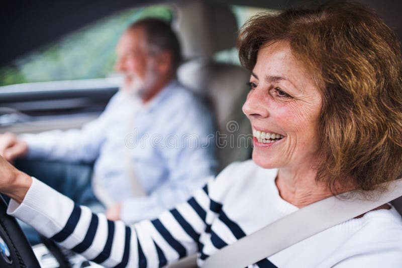 Happy senior couple sitting in car, driving and talking. royalty free stock photo Happy senior couple sitting in car, driving and talking. royalty free stock photo