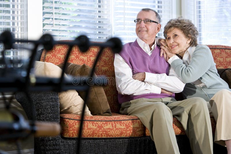 Happy senior couple sitting together on couch royalty free stock image Happy senior couple sitting together on couch royalty free stock image