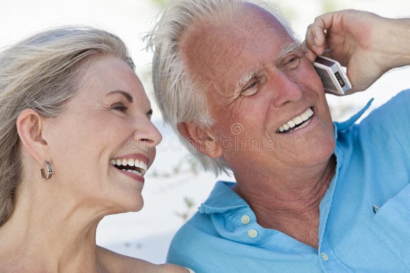 Feliz hombre una mujer sonriente mientras discurso sobre el móvil teléfono móvil.