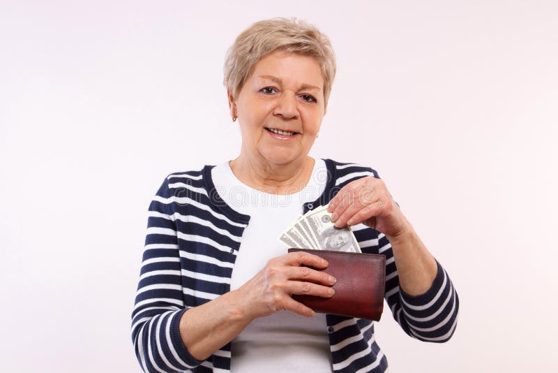 Happy senior female holding wallet with currencies dollar, concept of financial security in old age