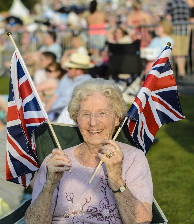 Happy Senior Lady Waves British Flags royalty free stock images Happy Senior Lady Waves British Flags royalty free stock images