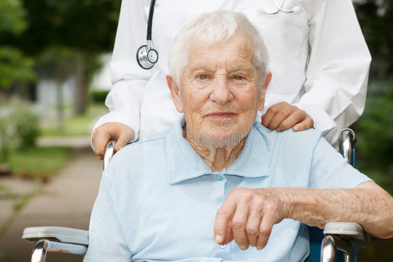 Happy senior lady in wheelchair stock photos