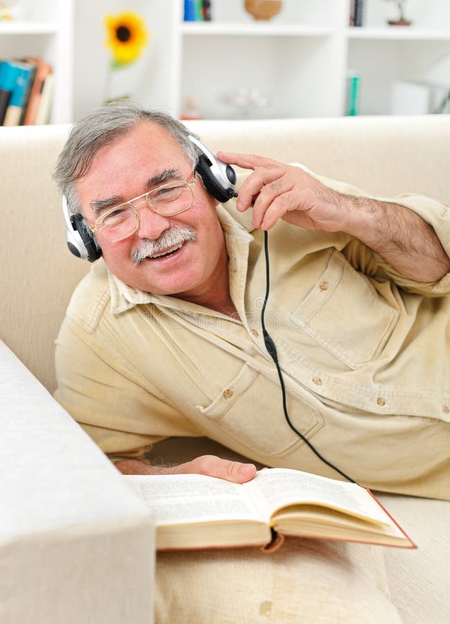 Happy senior man listening to music