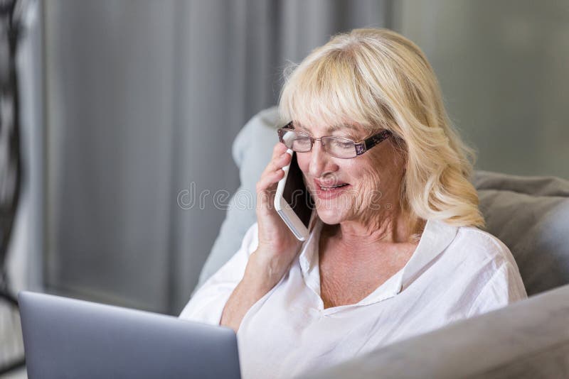 Happy senior woman talking on mobile phone royalty free stock image