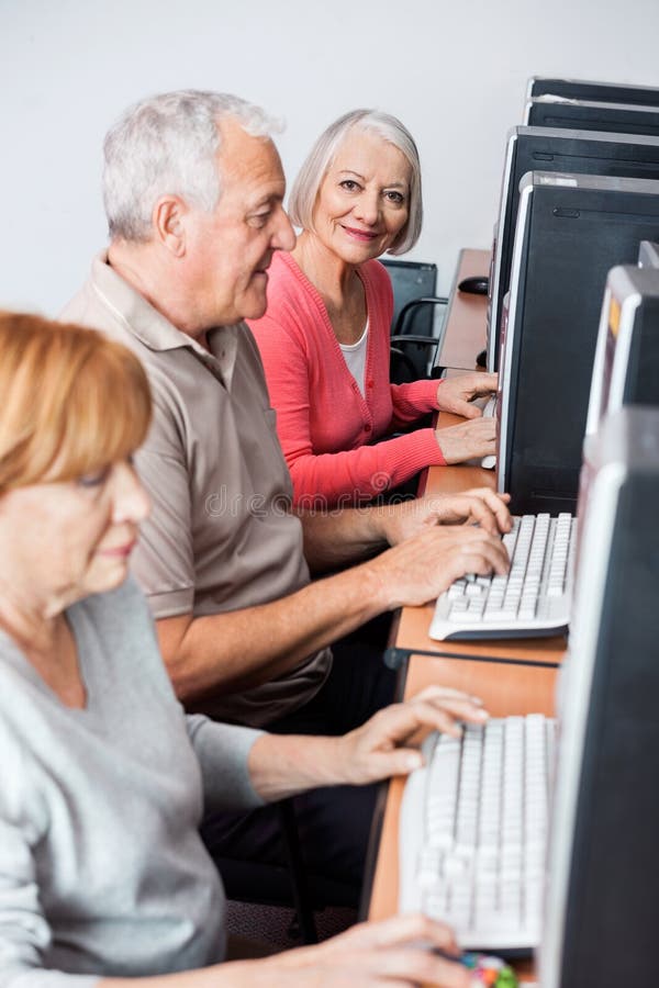 Happy Senior Woman Using Computer in Class Stock Image - Image of