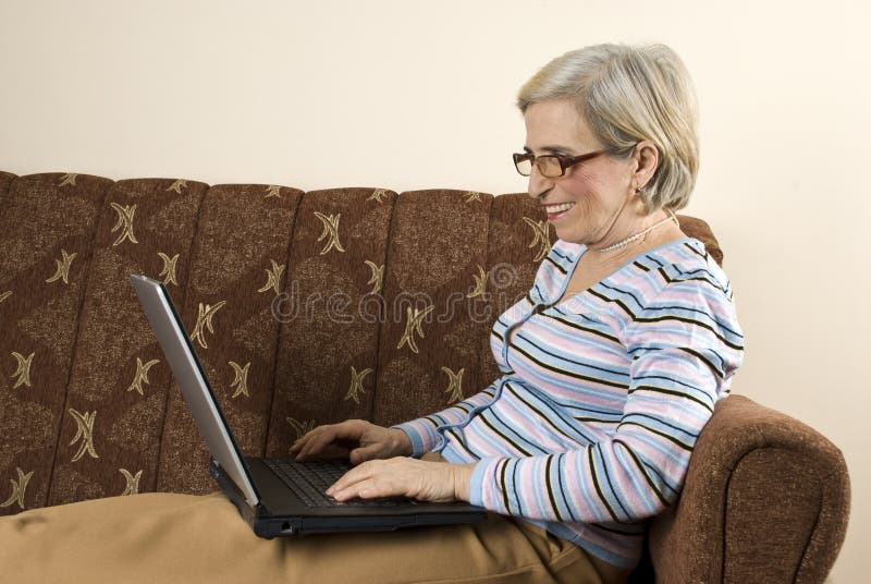 Happy senior woman using laptop