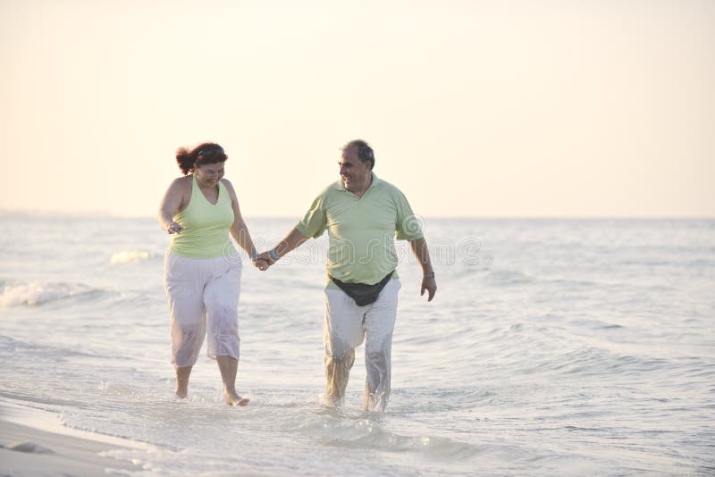 Happy seniors couple on beach