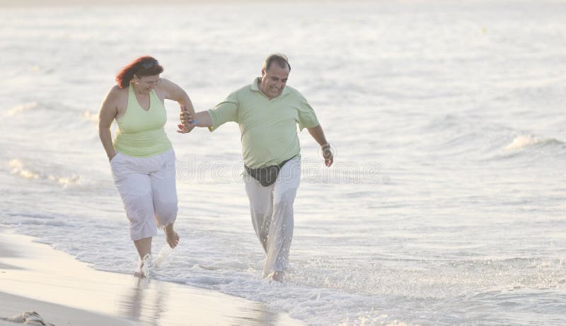 Happy seniors couple on beach