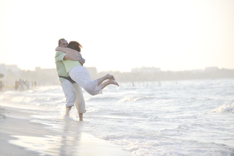 Happy seniors couple on beach