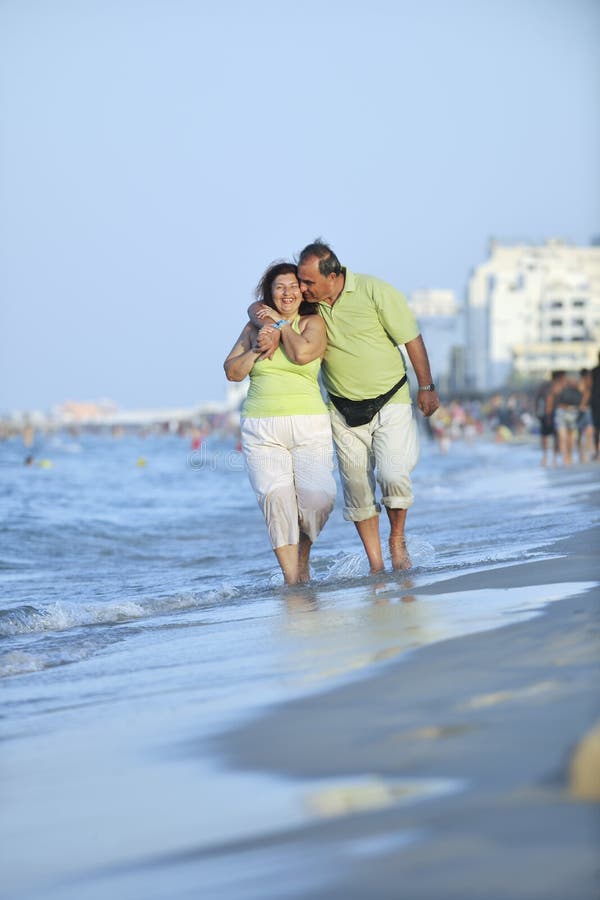 Happy seniors couple on beach