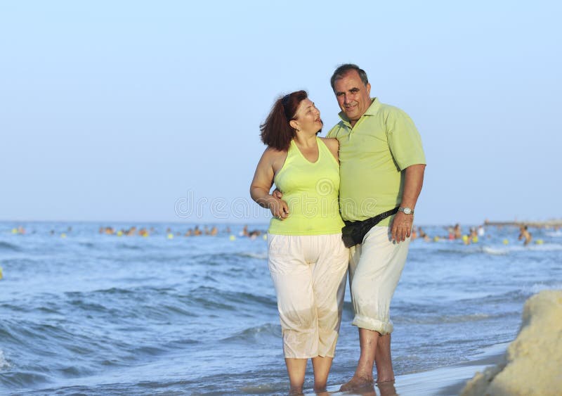 Happy seniors couple on beach