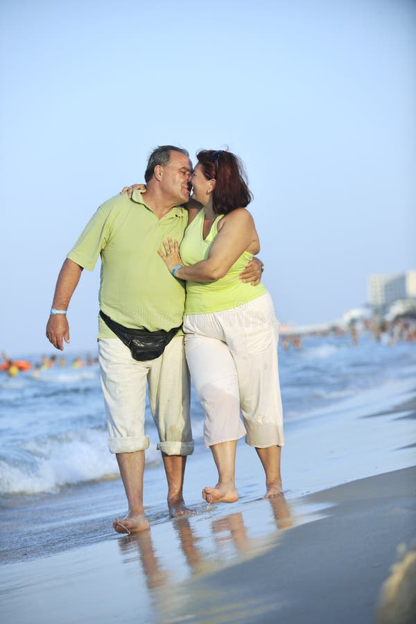 Happy seniors couple on beach