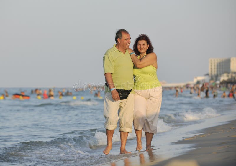 Happy seniors couple on beach