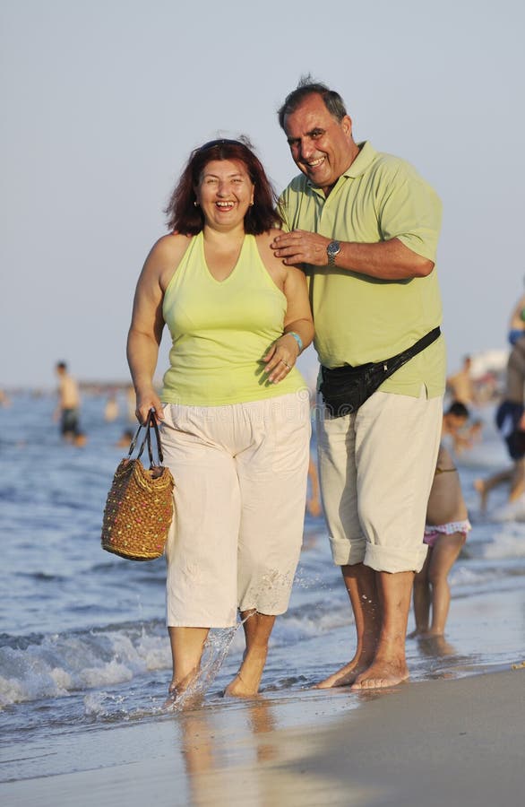 Happy seniors couple on beach