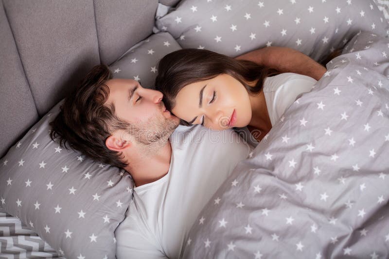 Happy sensual young couple lying in bed together. stock images Happy sensual young couple lying in bed together. stock images