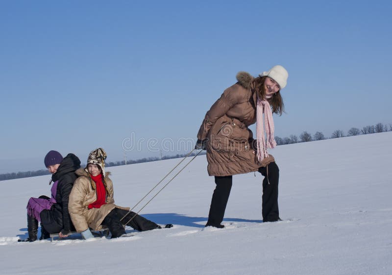 Happy sisters sledding stock photos