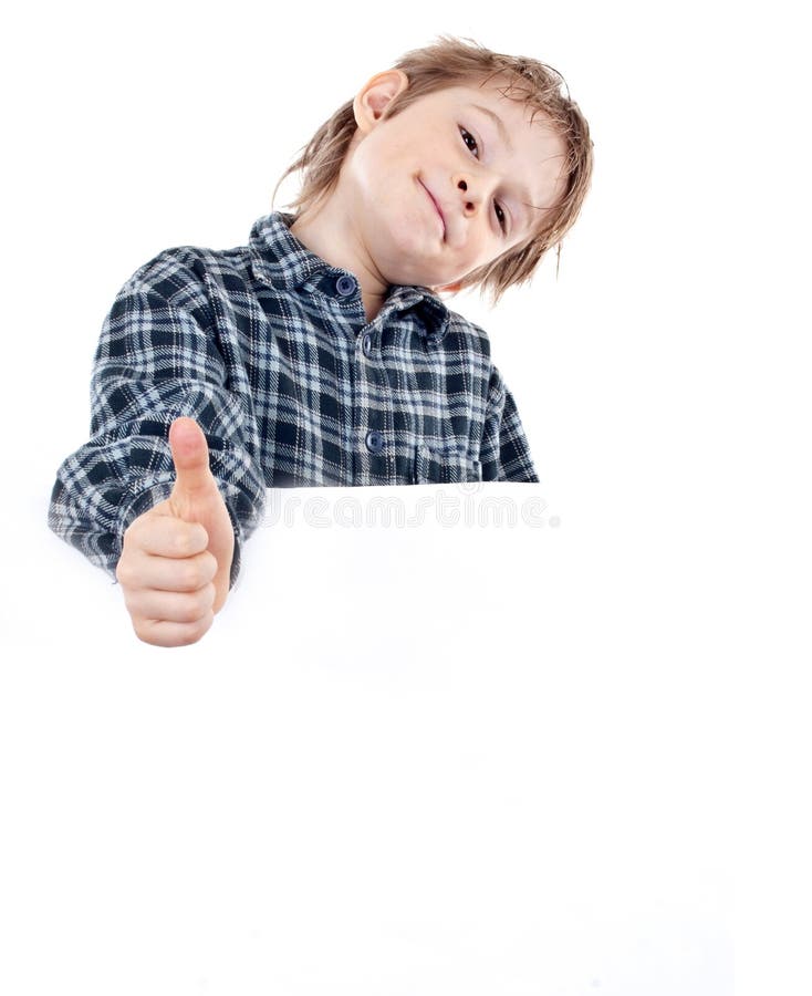 Happy small boy holding a blank board against whit