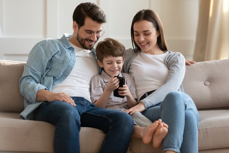 Happy Small Boy Showing Funny Video on Smartphone To Parents. Stock Photo - Image of phone, devotion: 192577618 Happy Small Boy Showing Funny Video on Smartphone To Parents. Stock Photo - Image of phone, devotion: 192577618