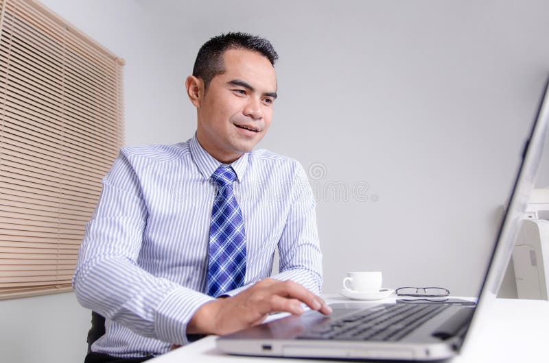 Happy smile business man using laptop computer in office