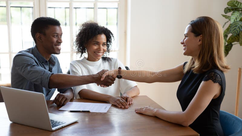 Happy African married couple shake hands to mortgage insurance broker