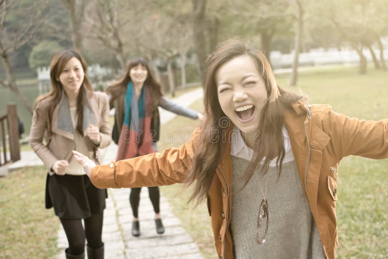 Happy smiling Asian women playing in the park, taipei, Taiwan.