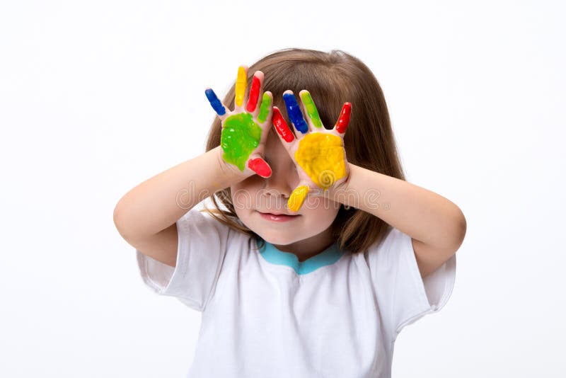 Happy smiling beautiful little girl with her colorful hands in the paint isolated on white background