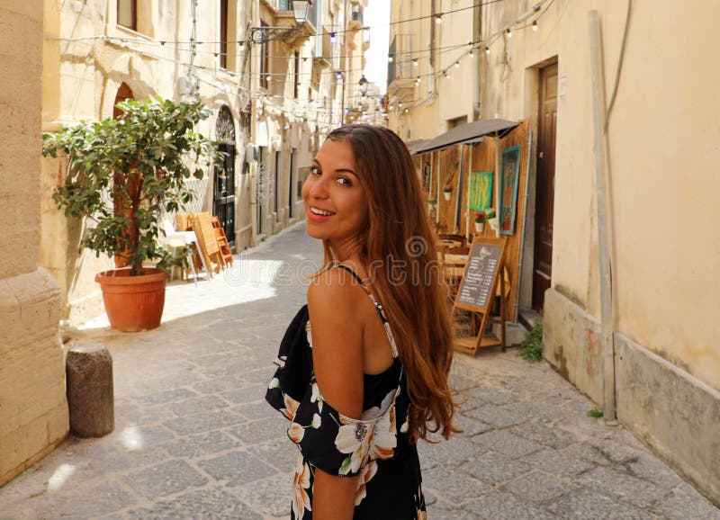 Premium Photo  Seductive sicilian woman sitting on a step in an old town  in sicily