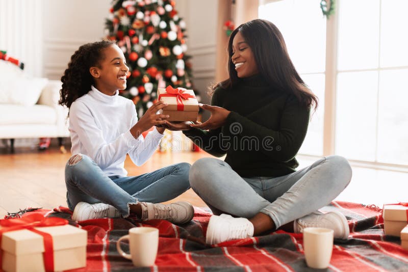 Happy Black Family Celebrating Christmas Exchanging Presents at Home ...