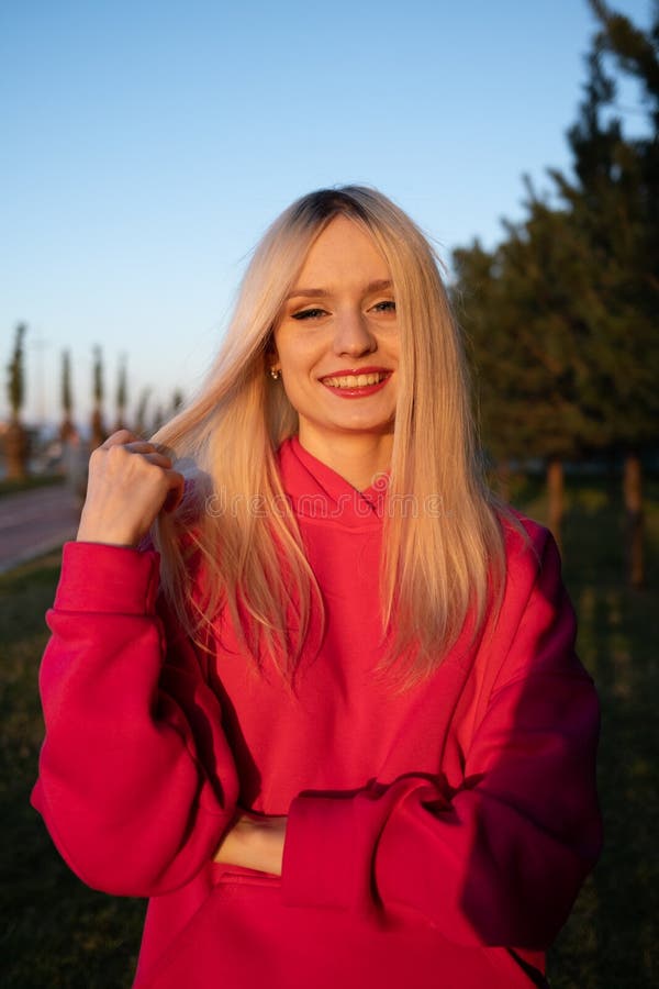 Happy Smiling Blonde Girl in a Pink Fleece Tracksuit Has a Good Time ...
