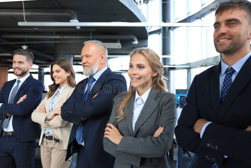 Happy smiling business team standing in a row at office royalty free stock images