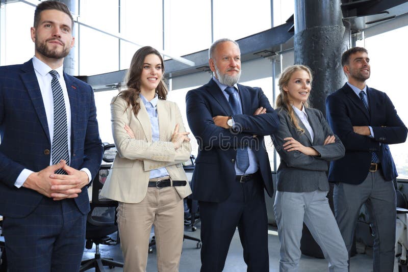 Happy smiling business team standing in a row at office stock photos
