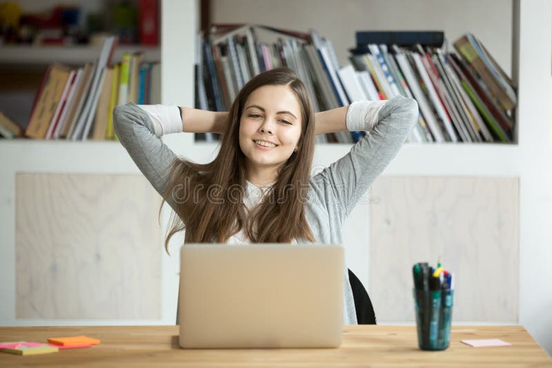 Happy smiling businesswoman relaxing at work desk in modern offi royalty free stock photography
