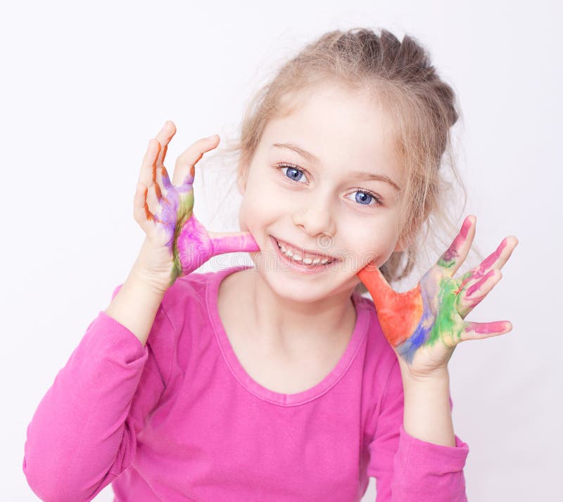 Happy smiling child girl having fun with painted hands