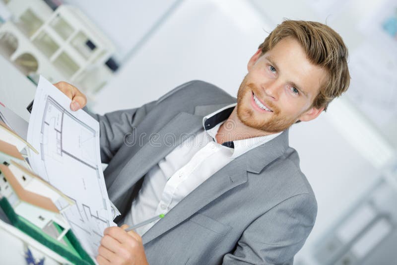 Happy smiling engineer working on plane house royalty free stock photography