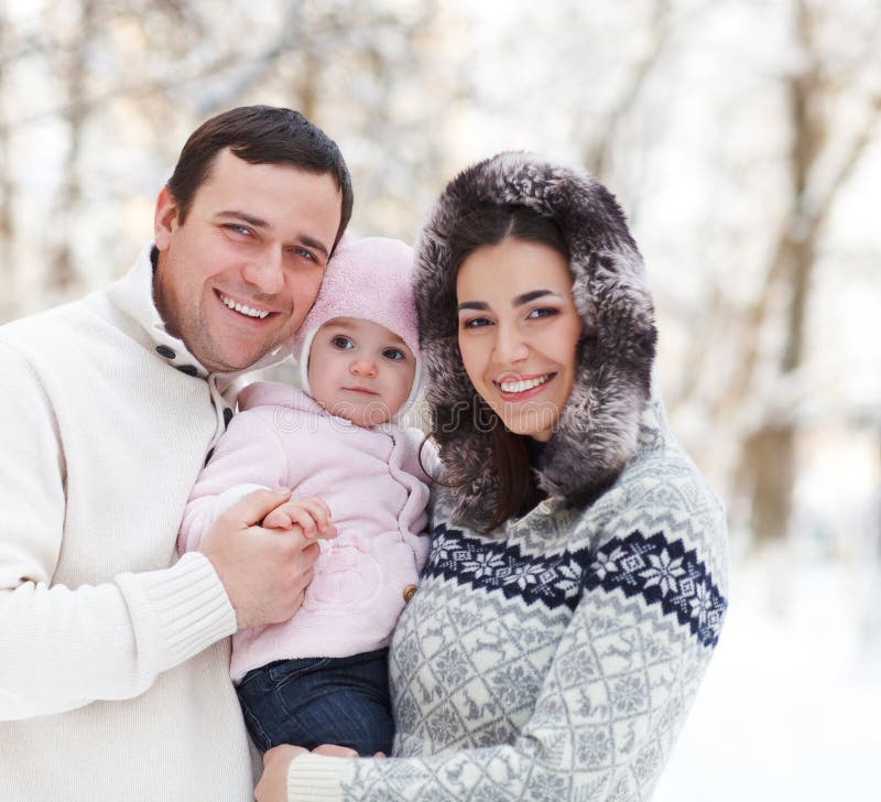 Happy smiling family with at the winter
