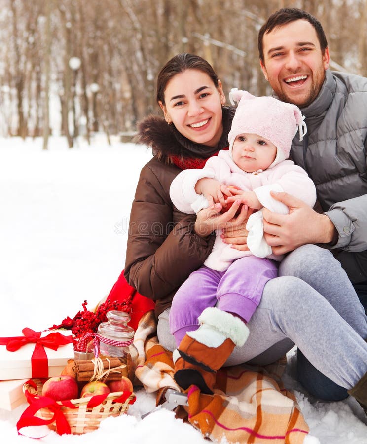 Happy smiling family with at the winter picnic stock photography Happy smiling family with at the winter picnic stock photography