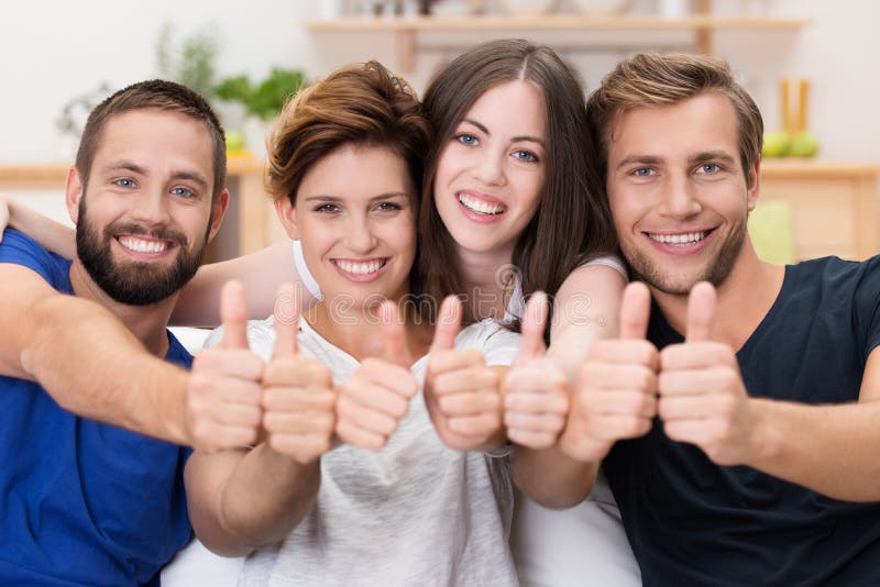 Happy smiling friends giving a thumbs up stock photo Happy smiling friends giving a thumbs up stock photo