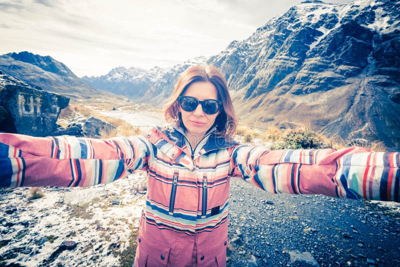 Happy smiling girl taking selfie in rocky Andes stock image Happy smiling girl taking selfie in rocky Andes stock image