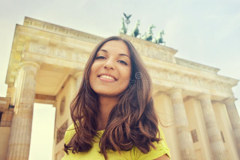 Happy smiling girl in front of Brandenburg Gate, Berlin, Germany. Beautiful young woman travel in Europe. royalty free stock photography Happy smiling girl in front of Brandenburg Gate, Berlin, Germany. Beautiful young woman travel in Europe. royalty free stock photography