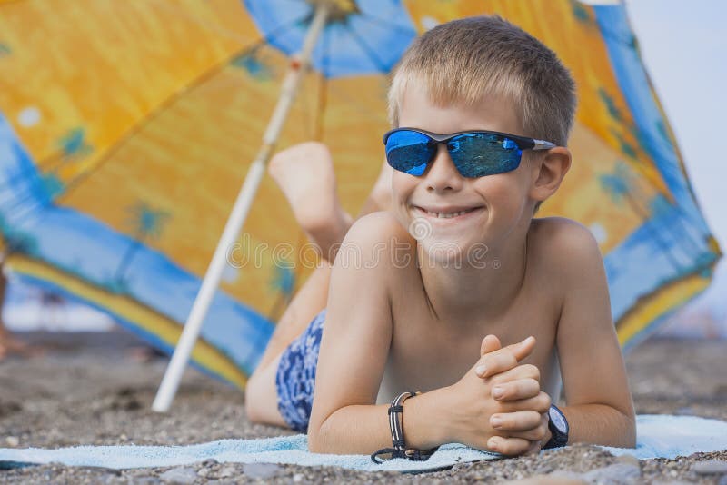 Happy Smiling Kid is Sunbathing on a Beach Stock Photo Image of ocean