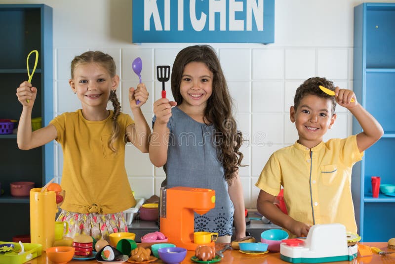 Happy smiling kids looking at camera at kids playroom. Children in entertainment center. Kids leisure concept stock photo Happy smiling kids looking at camera at kids playroom. Children in entertainment center. Kids leisure concept stock photo