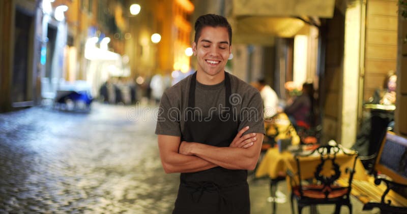 Happy smiling Latino male waiter wearing apron stock footage