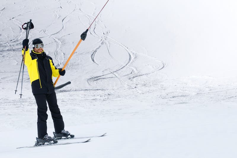 Happy skier using T-bar ski drag lift stock photos Happy skier using T-bar ski drag lift stock photos