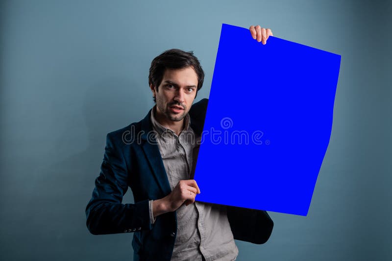 Happy smiling man showing blank signboard with empty copyspace area for slogan or advertising text message stock images