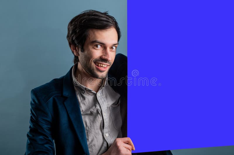 Happy smiling man showing blank signboard with empty copyspace area for slogan or advertising text message royalty free stock photos