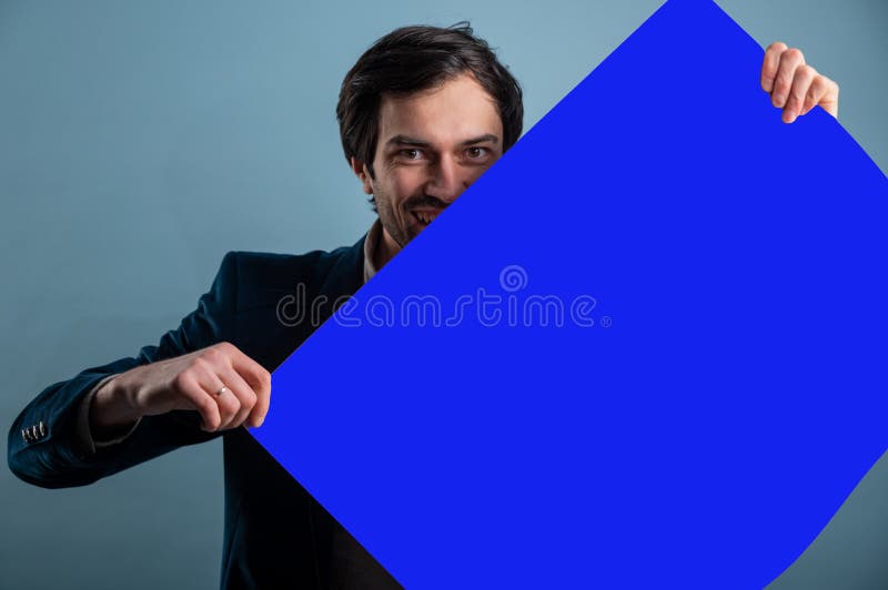 Happy smiling man showing blank signboard with empty copyspace area for slogan or advertising text message stock photography