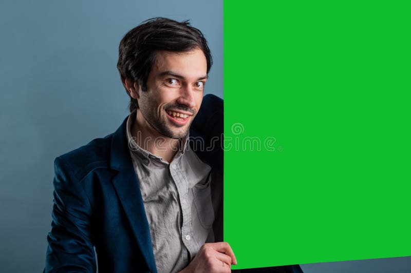 Happy smiling man showing blank signboard with empty copyspace area for slogan or advertising text message royalty free stock images